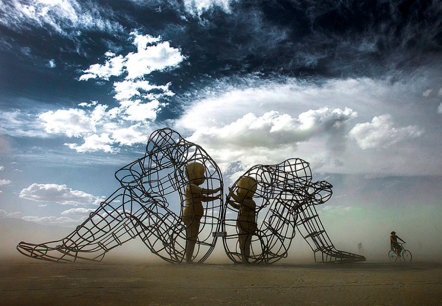 The image is of a sculpture titled Love by Alexander Milov from Odessa, Ukraine exhibited at the Burning Man Festival.
