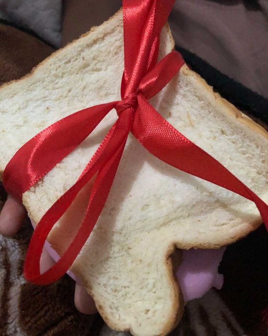 A slice of bread with red valentine ribbon