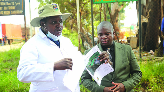 City of Harare Official (left) hands over Pomona dumpsite to Geo Pomona Waste Managenent represantive Dilesh Nguwaya