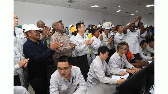 ZESA Holdings executive chairman Dr Sydney Gata (left) is joined by Deputy Chief Secretary in the Office of
the President and Cabinet in charge of flagship projects Engineer Amos Marawa (centre) and Sino Hydro
employees in celebrating the successful synchronisation of Unit 7 into the national grid in Hwange yesterday
- Pictures: Kudakwashe Hunda.
