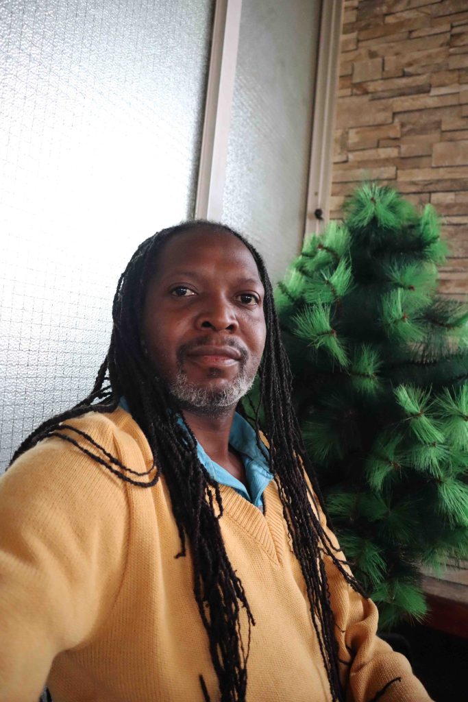 sitting next to a Christmas Tree