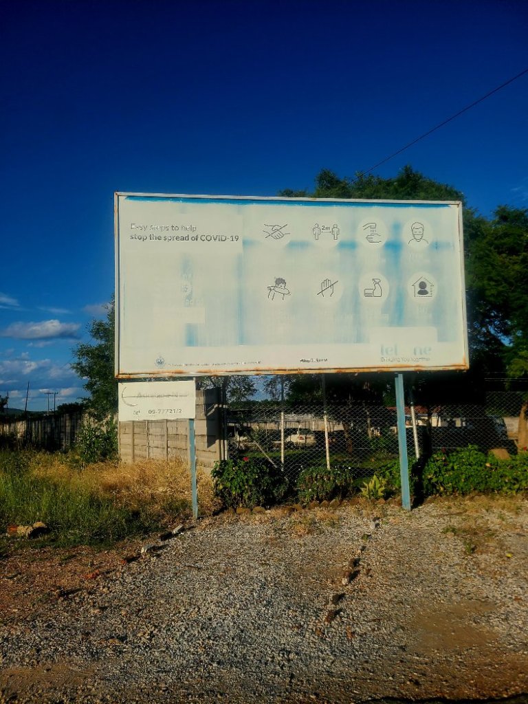 A Covid-19 Billboard with faded text